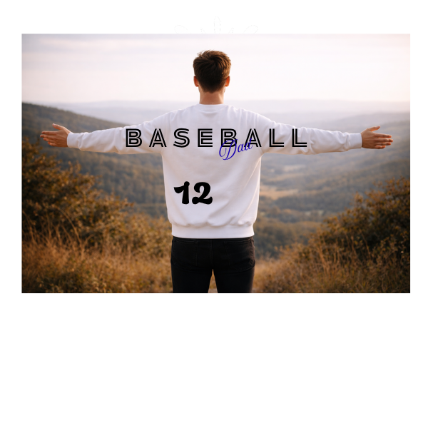 Person wearing a white shirt with 'BASEBALL 12' text standing outdoors.